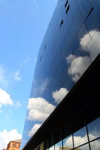 Low angle view of building against cloudy sky