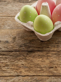 High angle view of easter eggs in carton on table