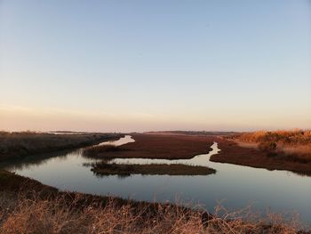 Scenic view of lake against sky during sunset