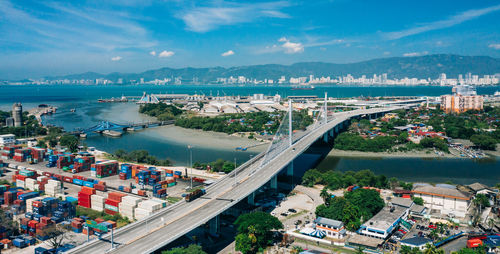 High angle view of cityscape by sea against sky