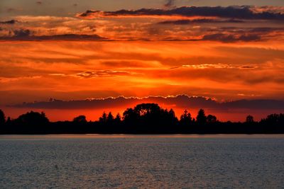 Scenic view of sea against orange sky