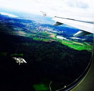 Cropped image of airplane wing over landscape