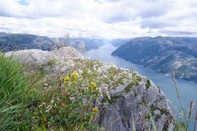 Scenic view of sea and mountains against sky