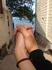 Midsection of woman hand on wall