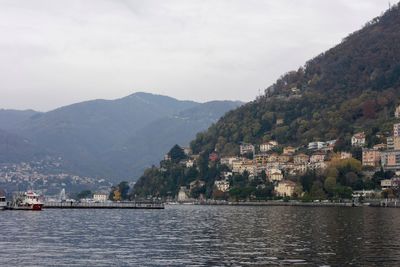 Scenic view of river by mountains against sky