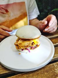 Midsection of man holding food on table