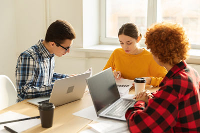 Side view of business colleagues working at office