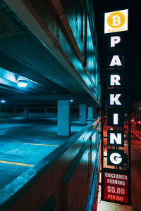 Illuminated road sign at night