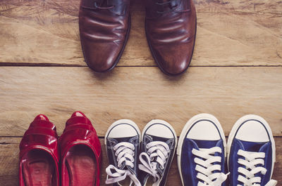 Directly above shot of various shoes arranged on hardwood floor