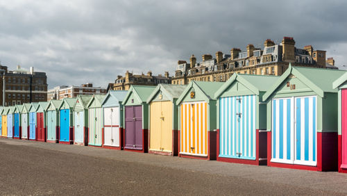 Beach huts against buildings in city