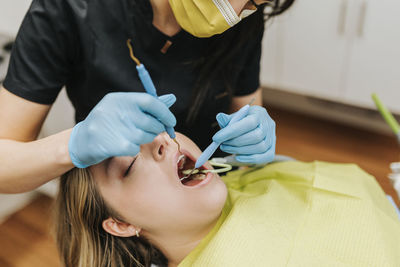 Dentist checking patient's teeth