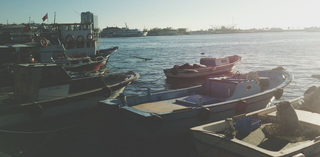 water, nautical vessel, moored, boat, transportation, mode of transport, sea, clear sky, tranquility, sky, nature, chair, tranquil scene, day, sunlight, scenics, absence, table, outdoors, no people