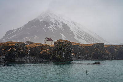 Scenic view of sea and mountains against sky