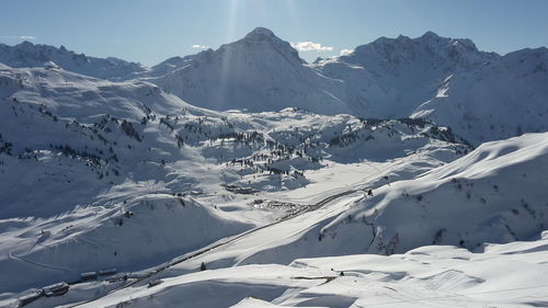 Scenic view of snow covered mountains against sky