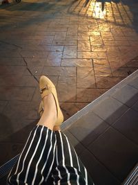 Low section of woman standing on tiled floor