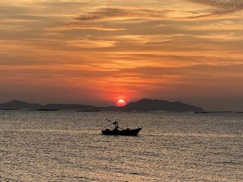 Scenic view of sea against orange sky