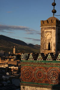 Mosque against buildings at dusk