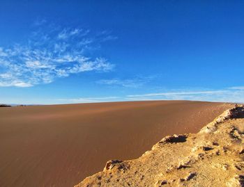 Scenic view of desert against blue sky