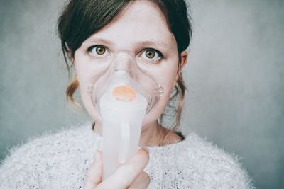 Close-up portrait of woman with oxygen mask