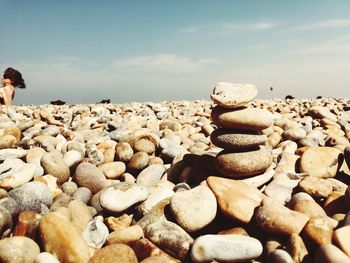 Stack of pebbles on beach against sky