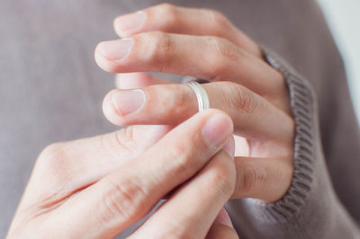 Close-up of woman holding wedding ring