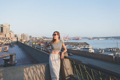 Woman standing on bridge over river