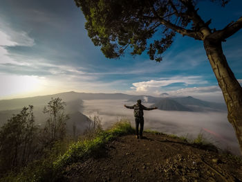 Full length of man standing on field against sky