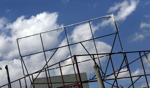 Low angle view of glass building against sky