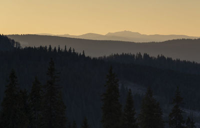 Scenic view of silhouette mountains against sky during sunset