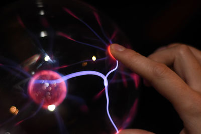 Close-up of hand holding illuminated lights