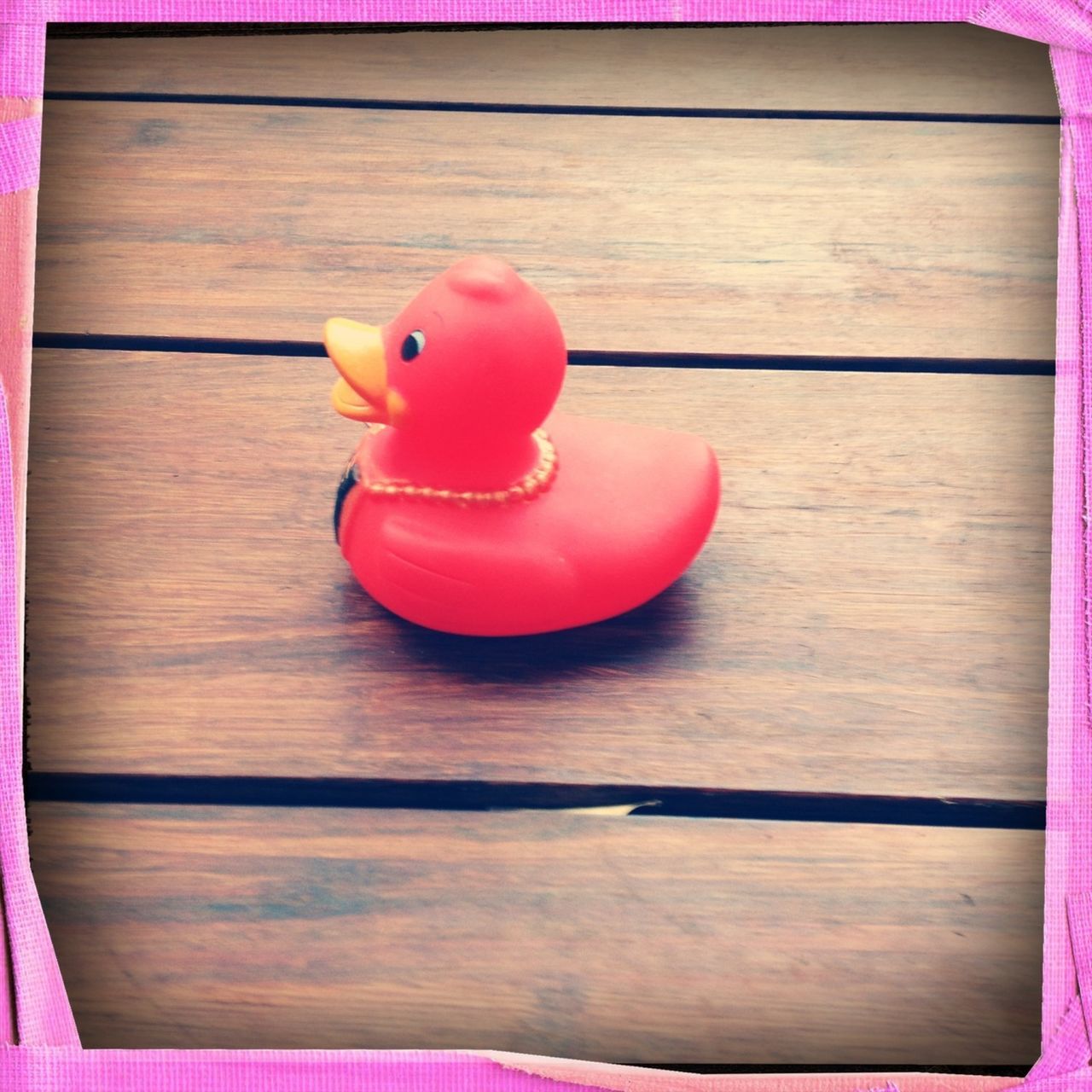 indoors, table, red, wood - material, still life, wooden, transfer print, auto post production filter, toy, close-up, high angle view, food and drink, pink color, childhood, animal representation, wood, single object, no people, plank, food