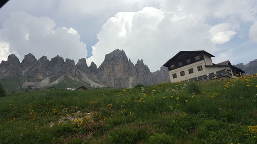 Panoramic view of buildings on field against sky