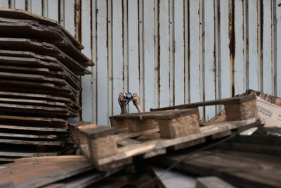 Person photographing behind palettes