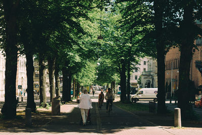 People walking on sidewalk in city