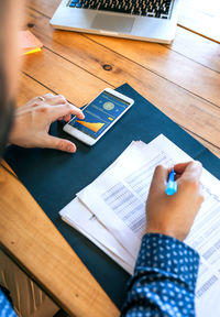 Cropped image of business colleagues working on table