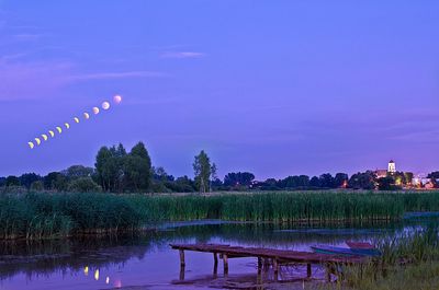 Scenic view of lake against sky at night