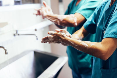 Nurses washing hands at sink