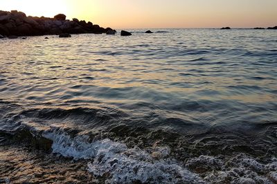 Scenic view of sea against sky at sunset