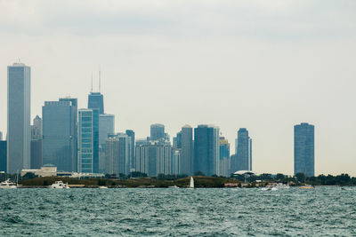 City at waterfront against sky