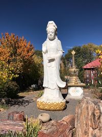 Statue against trees and clear sky