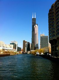 Buildings in city against clear sky