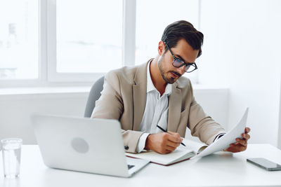 Businesswoman using laptop at office