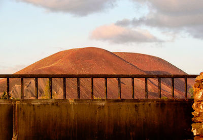 Built structure on field against sky