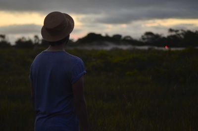Rear view of a man standing on field