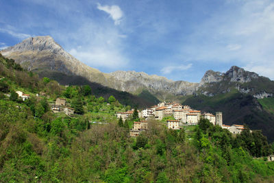 Townscape by mountain against sky