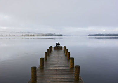 Pier on lake against sky