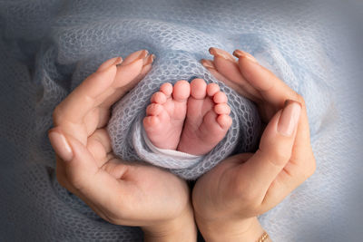 Cropped hand of person holding baby