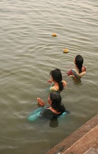 High angle view of women praying in river