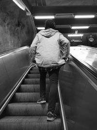 Rear view of man on escalator