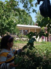 Girl and plants against trees